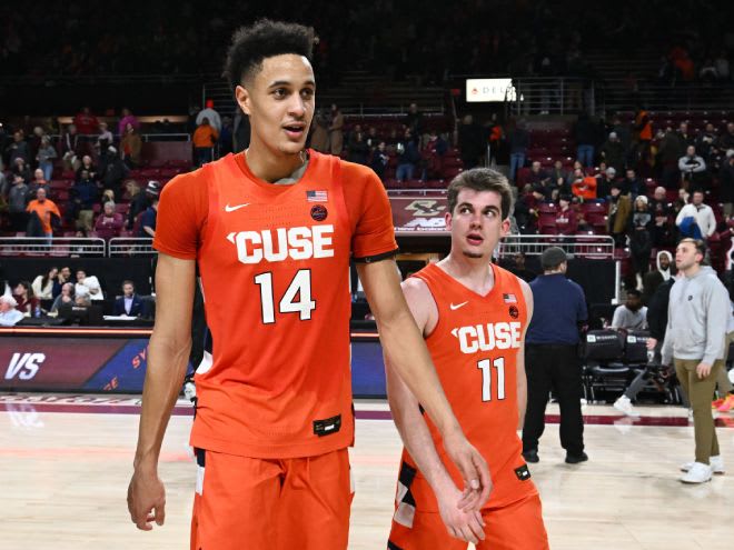 Feb 4, 2023; Chestnut Hill, Massachusetts, USA; Syracuse Orange center Jesse Edwards (14) walks off of the court with guard Joseph Girard III (11) after a game against the Boston College Eagles at the Conte Forum. Mandatory Credit: Brian Fluharty-USA TODAY Sports