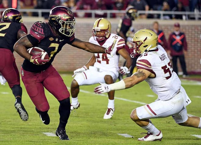 Cam Akers stiff-arms Boston College linebacker Isaiah McDuffie on his touchdown run on Saturday night. 