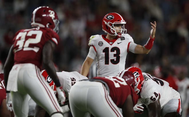Stetson Bennett relays an instruction to a receiver before a play against Alabama. (Skylar Lien/UGA Sports Communications)