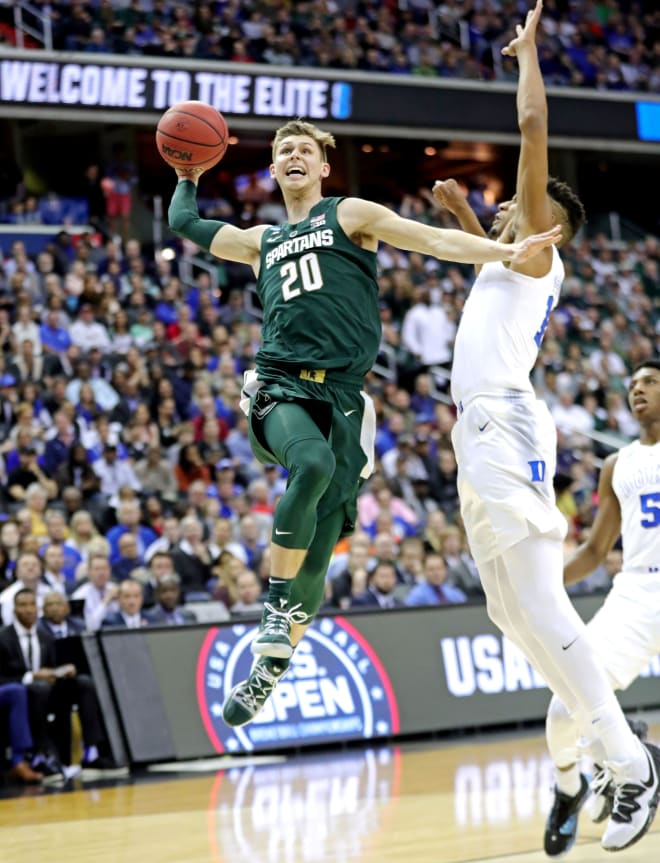 Michigan State guard Matt McQuaid (20) dunks the ball against Duke forward Javin DeLaurier (12) during the first half of the East Region final of the NCAA tournament on Sunday, March 31, 2019, in Washington.