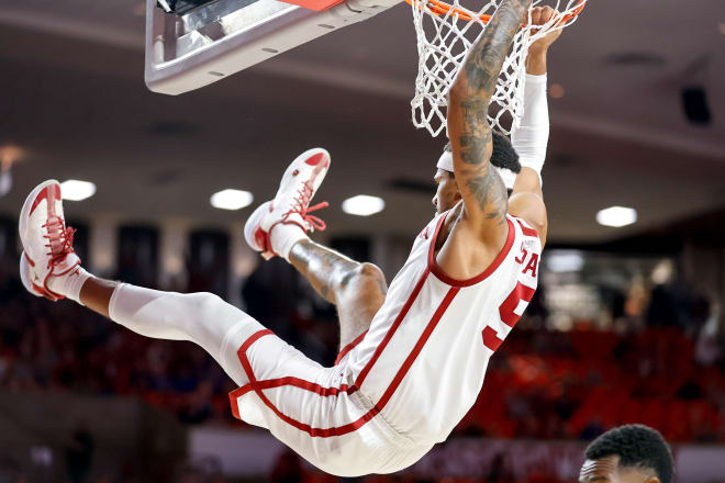 Rivaldo Soares hanging on the rim after a dunk