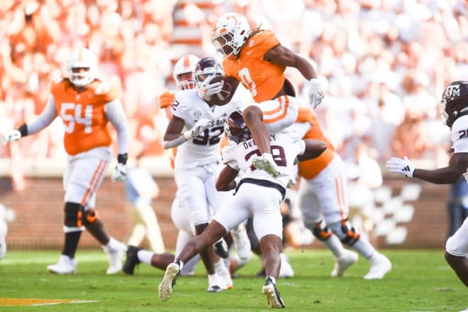 Tennessee running back Jaylen Wright (0) hurdles Texas A&M defensive back Josh DeBerry (28) during a football game between Tennessee and Texas A&M at Neyland Stadium in Knoxville, Tenn., on Saturday, Oct. 14, 2023.