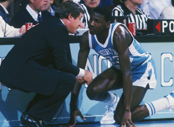 MJ and Dean Smith during a game at Carmichael Auditorium. 