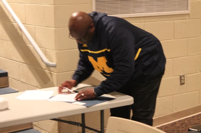 Johnson's father, James, signs the Letter of Intent.