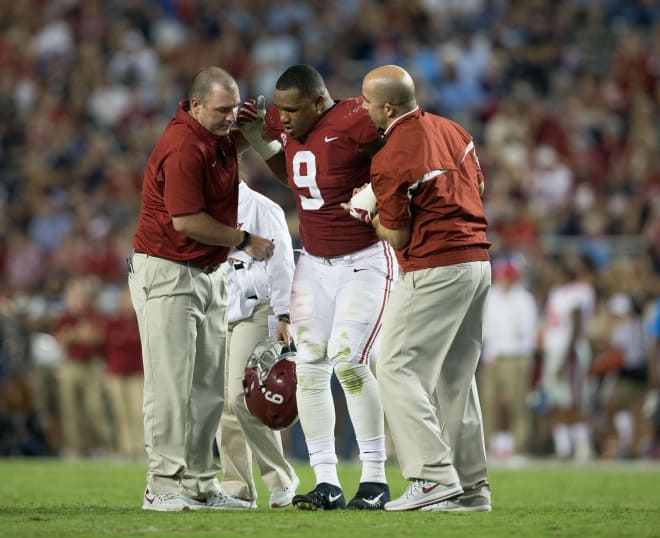 Alabama Crimson Tide defensive lineman Da'Shawn Hand (9) is helped up after suffering an injury during a play against the Mississippi Rebels at Bryant-Denny Stadium. Photo | USA Today