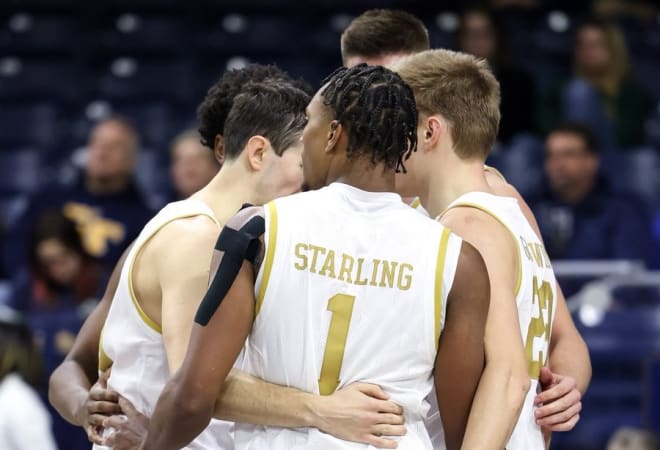 Notre Dame's players huddle during a 73-72 Irish overtime victory on Tuesday night.