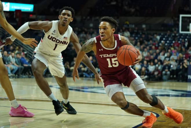 Temple Owls guard Nate Pierre-Louis drives the ball against Connecticut guard Christian Vital in a game at Harry A. Gampel Pavilion. 