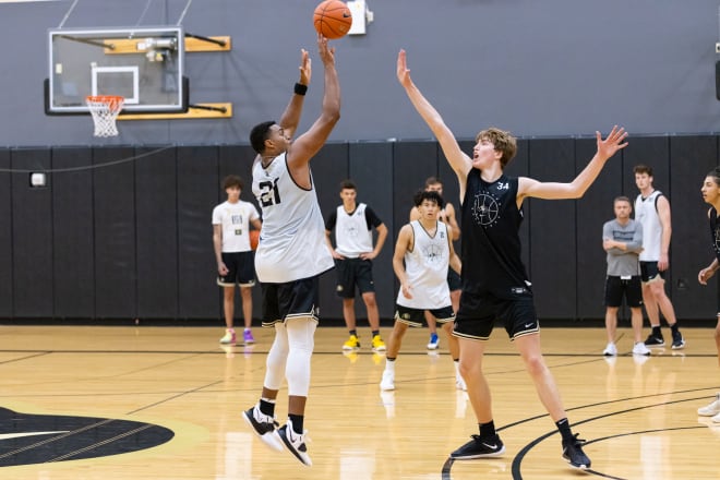 Evan Battey takes a three-point shot in front of Lawson Lovering at the CU Events Center back in August