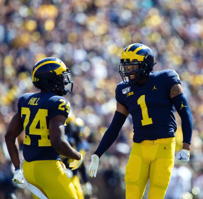 Michigan Wolverines football senior cornerback Lavert Hill (left) recorded his fourth career interception yesterday.