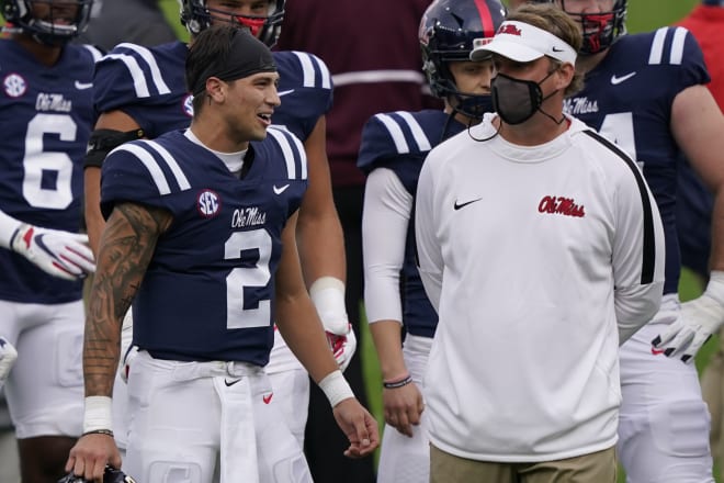 Ole Miss quarterback Matt Corral and coach Lane Kiffin converse during the Rebels' Egg Bowl win over Mississippi State Saturday.