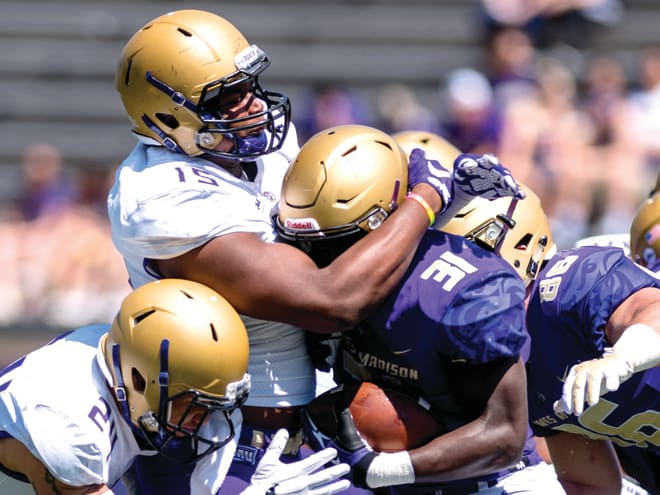 James Madison defensive end Ron'Dell Carter (15) wraps up running back Percy Agyei-Obese during the Dukes' spring game in April.