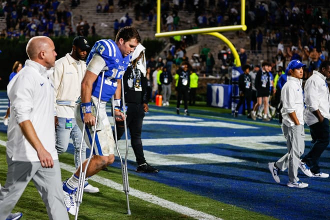 Then-Duke quarterback Riley Leonard leaves the field on crutches after a 21-14 loss to Notre Dame on Sept. 30.