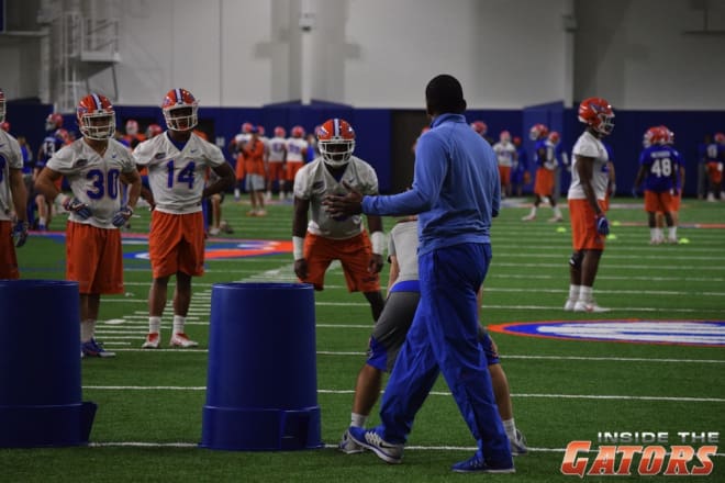 Gators defensive coordinator Randy Shannon works with the safeties