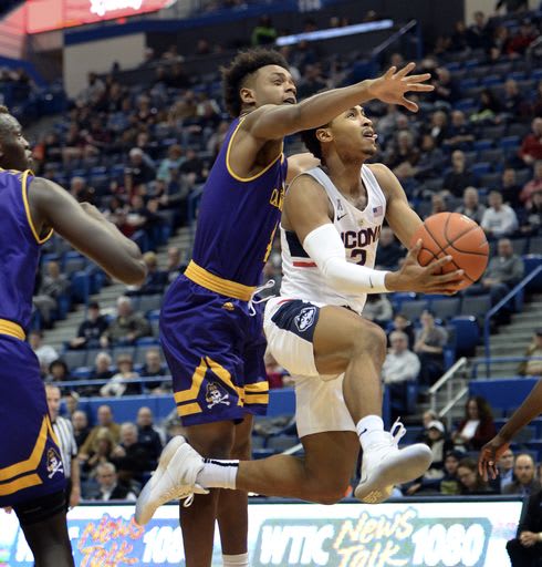 Connecticut guard Jalen Adams drives past East Carolina's Elijah Hughes in UConn's 72-65 victory.