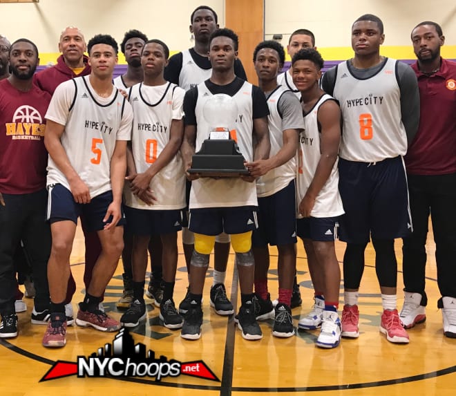 PG Joe Toussaint hold Hype City VIII championship trophy surrounded by teammates