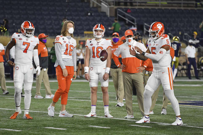 With Trevor Lawrence (16) looking on, Clemson QB DJ Uiagalelei warms up ahead of Notre Dame's 47-40 win in double overtime over the top-ranked Tigers on Nov. 7, 2020.