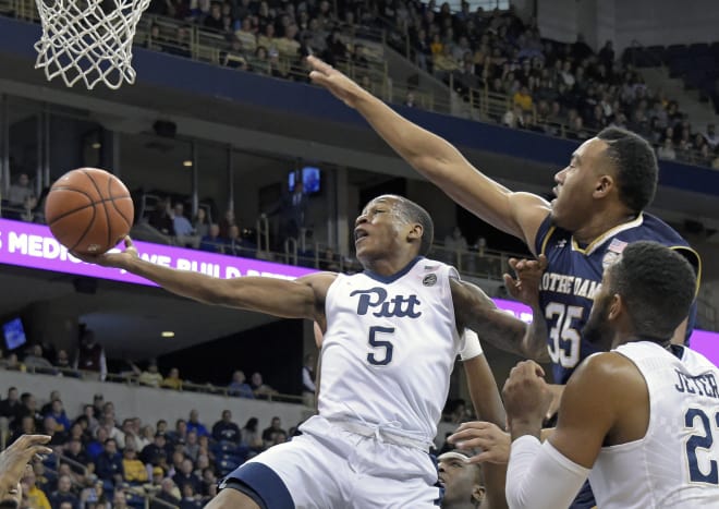Pittsburgh guard Justice Kithcart (left) goes up for a shot against Notre Dame forward Bonzie Colson  during the first half.
