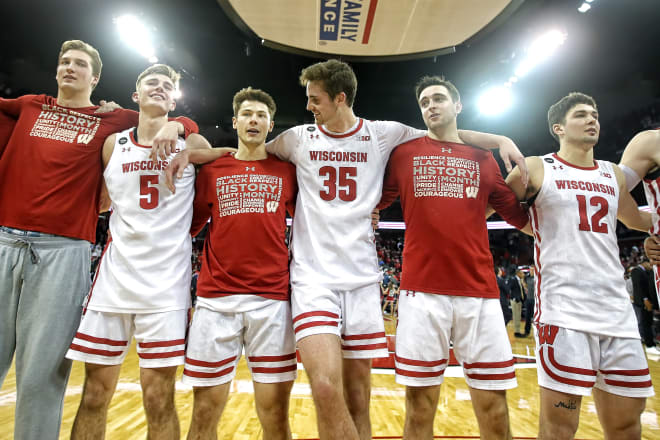 Members of the Wisconsin Badgers sign 'Varsity' following their win over No.14 Michigan State