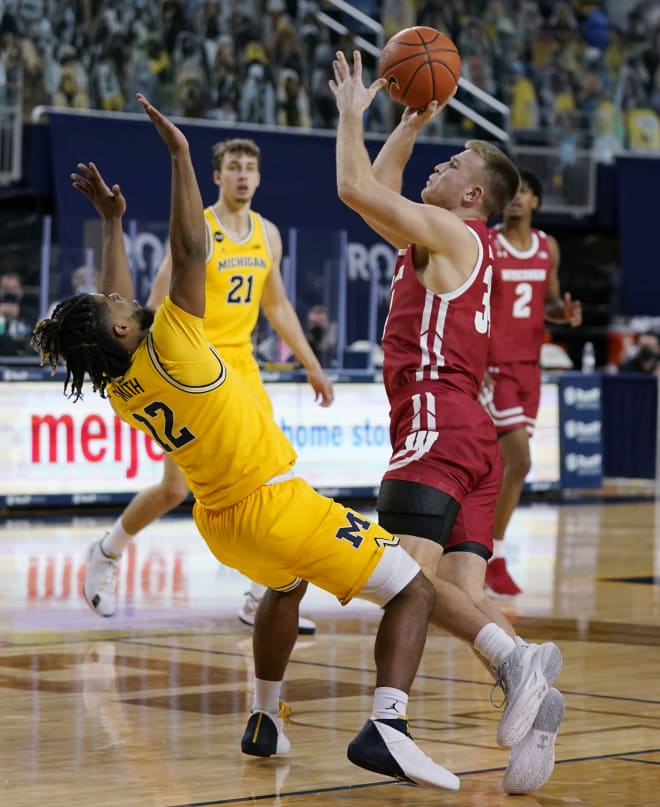 Michigan Wolverines basketball fifth-year senior guard Mike Smith shut down Wisconsin's Brad Davison. 