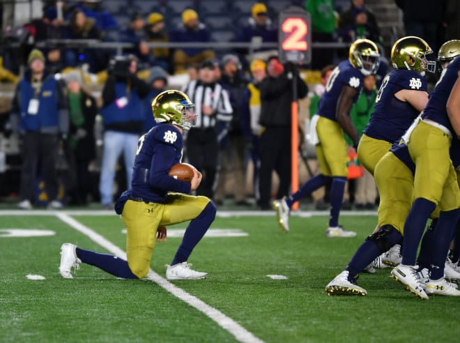 Notre Dame backup quarterback Phil Jurkovec taking a knee at the end of the game against Navy (Photos by Andris Visocks)