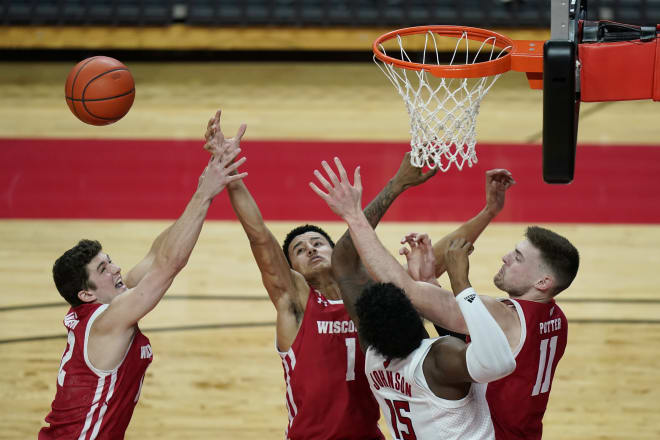 Wisconsin's Trevor Anderson, Jonathan Davis and Micah Potter, from left, and and Rutgers' Myles Johnson vie for a rebound during the second half. Wisconsin won 60-54.