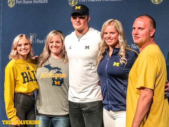 Three-star strongside defensive end Braiden McGregor poses with his family after committing to Michigan.
