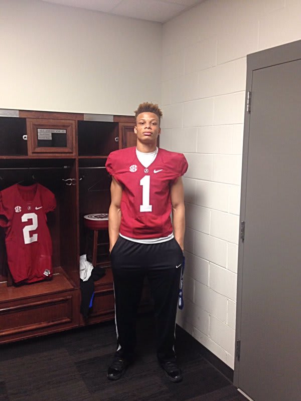 Woods poses in an Alabama jersey during his visit to Tuscaloosa 