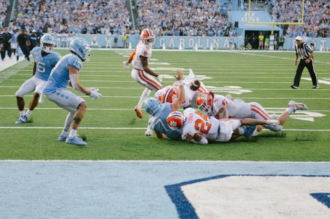 UNC offensive coordinator Phil Longo explains why the Tar Heels ran the triple option on their two-point conversion attempt Saturday.