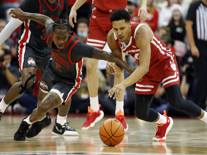 Ohio State guard Cedric Russell, left and Wisconsin guard Jordan Davis chase a loose ball.