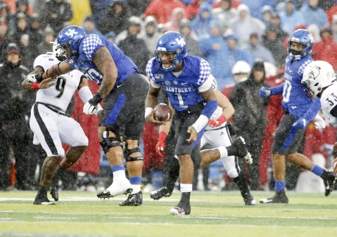 Kentucky's Lynn Bowden Jr. races for one of his four touchdowns in Saturday's win over Louisville. 