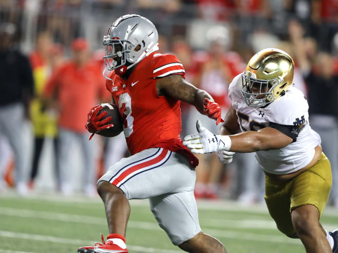 Ohio State running back Miyan Williams, right, runs away from Notre Dame defensive lineman Howard Cross III.