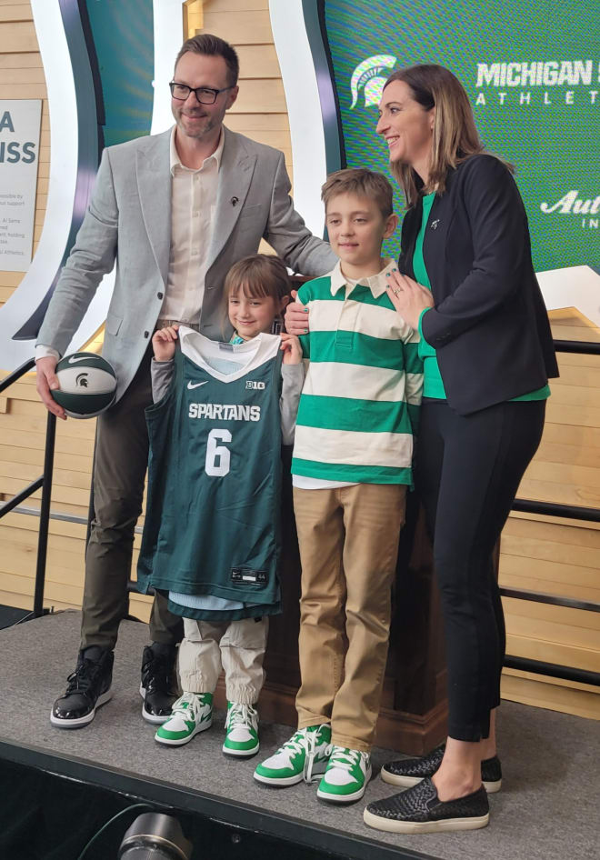 Coach Fralick and her family pose for a photo at her introductory press conference on April 4, 2023.