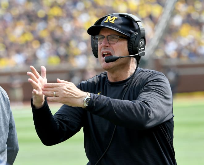 Michigan Wolverines football coach Jim Harbaugh and his players started fall practice Friday.