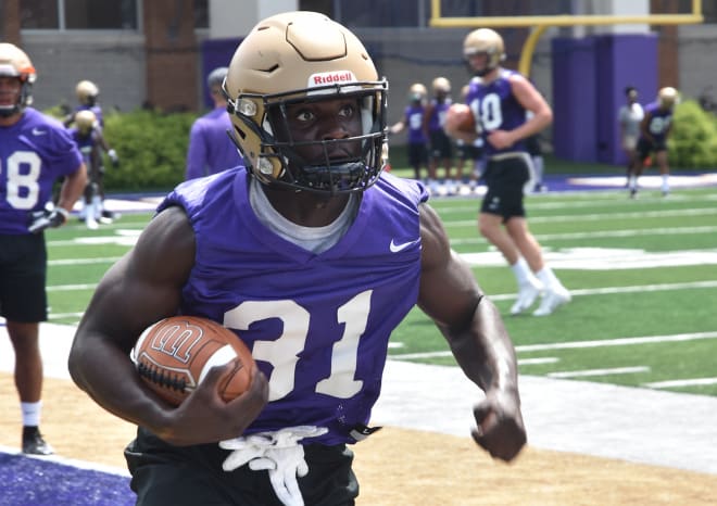 James Madison running back Percy Agyei-Obese carries the ball through a drill during a practice earlier this month at Bridgeforth Stadium in Harrisonburg.
