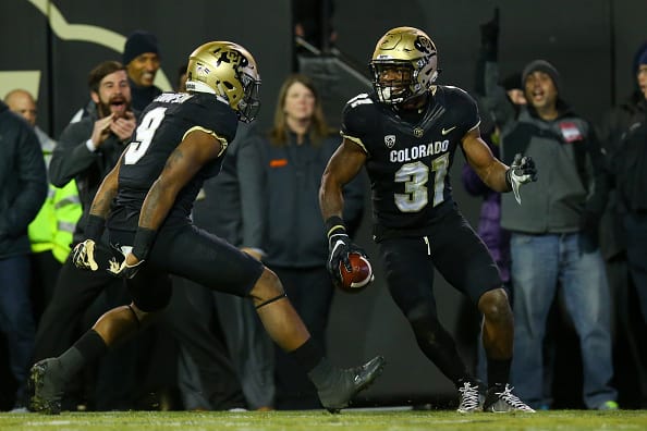 BOULDER, CO - NOVEMBER 26: Linebacker Kenneth Olugbode #31 of the Colorado Buffaloes celebrates his fumble recovery and return for a touchdown with defensive back Tedric Thompson #9 during the fourth quarter against the Utah Utes at Folsom Field on November 26, 2016 in Boulder, Colorado. Colorado defeated Utah 27-22 and win the Pac-12 South. The Buffaloes will play Washington next week in the Pac-12 Championship. (Photo by Justin Edmonds/Getty Images)