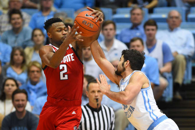 NC State fifth-year senior forward Torin Dorn and UNC senior post player Luke Maye battled for the ball Tuesday. UNC won 113-96 over NC State in Chapel Hill, N.C.