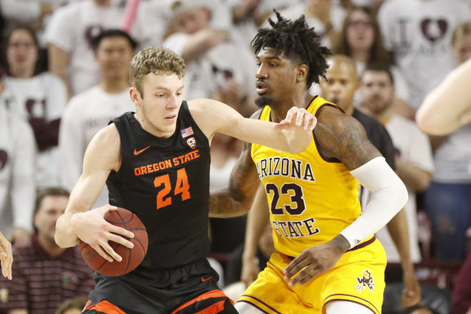 Oregon State's Kylor Kelly (24) controls the ball against Arizona State's Romello White (23) during the second half of an NCAA college basketball game Thursday, Feb. 20, 2020, in Tempe, Ariz.