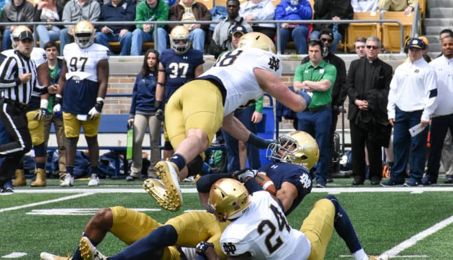 Multiple Irish players including defensive back Nick Watkins (24) and Greer Martini (48) bring down wide receiver Equanimeous St. Brown.