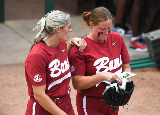 Injured Alabama pitcher Montana Fouts talks to Alabama pitcher Alex Salter (27) as she enters the game in relief Sunday during the Tuscaloosa Regional Final doubleheader. Photo | Gary Cosby Jr.-Tuscaloosa News / USA TODAY NETWORK