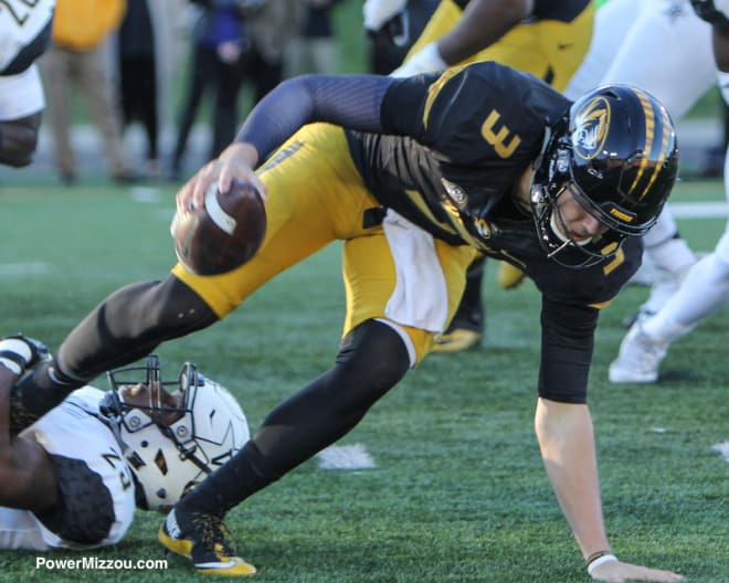 QB Drew Lock runs out of a tackle