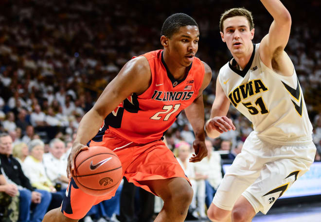 Illinois Fighting Illini guard Malcolm Hill (21) goes to the basket as Iowa Hawkeyes forward Nicholas Baer (51) defends during the first half at Carver-Hawkeye Arena.