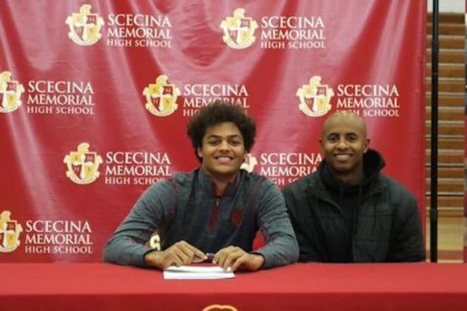 Indiana wide receiver signee David Baker with former Harlem Globetrotter and assistant Scecina Memorial basketball coach Derick Grant during Baker's signing with Indiana on Dec. 18, 2019. (courtesy photo)