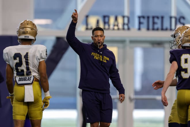 Notre Dame coach Marcus Freeman (center) has a strategy to protect his roster.