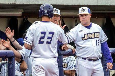 Second-year James Madison coach Marlin Ikenberry (right) high-fives Tanner Dofflemyer during a game last season.