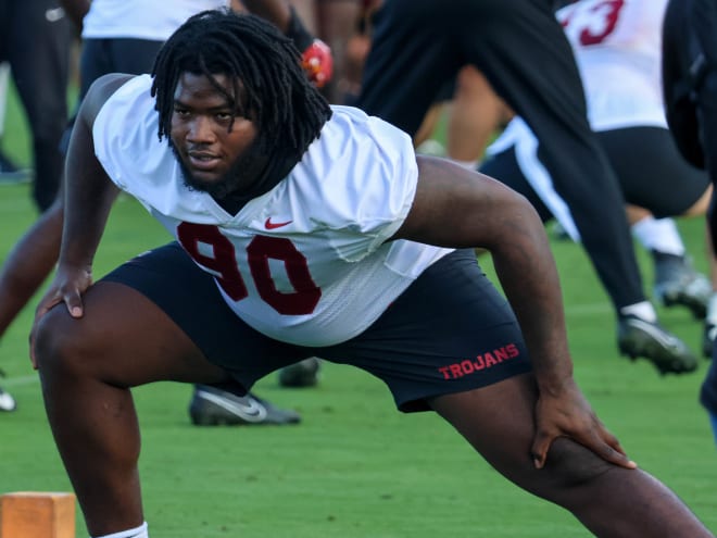 Bear Alexander stretches before USC's first practice of fall camp Friday.