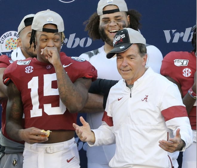 Alabama defensive back Xavier McKinney (15) laughs as Head Coach Nick Saban strikes a pose with his hat askew after the Crimson Tide defeated Michigan 35-16 in the Citrus Bowl Jan. 1, 2020 in Orlando. Photo | USA Today