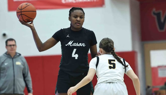 Mason guard Madison Parrish (4) brings the ball up court against Centerville's Amelia Davis (5) drives to the basket during their district final win Saturday, March 2, 2024. © Tony Tribble for The Enquirer / USA TODAY NETWORK