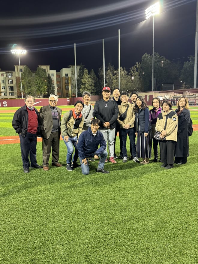 Rintaro Sasaki takes a picture with some fans from Japan. 