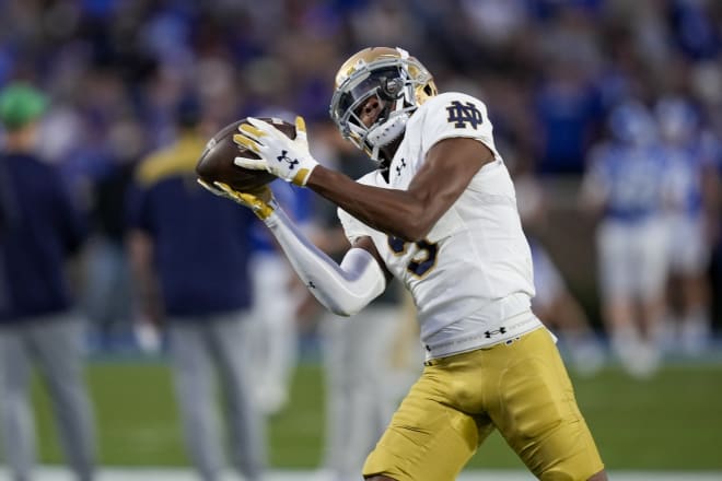 Notre Dame wide receiver Tobias Merriweather tries to hold on for a pass reception during a catchless game against Duke last Saturday night.