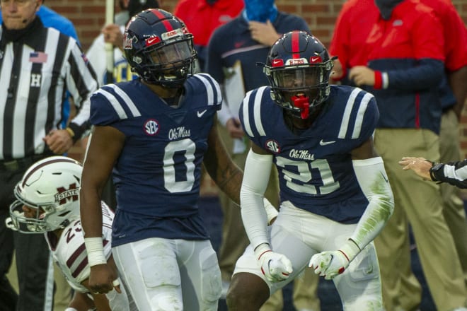 Ole Miss' Lakia Henry (0) and A.J. Finley (21) celebrate a stop during the Rebels' Egg Bowl win over Mississippi State Saturday.